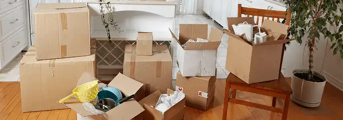 Packed moving boxes and household items in a kitchen before move-out or move-in cleaning, Grand Rapids, MI.